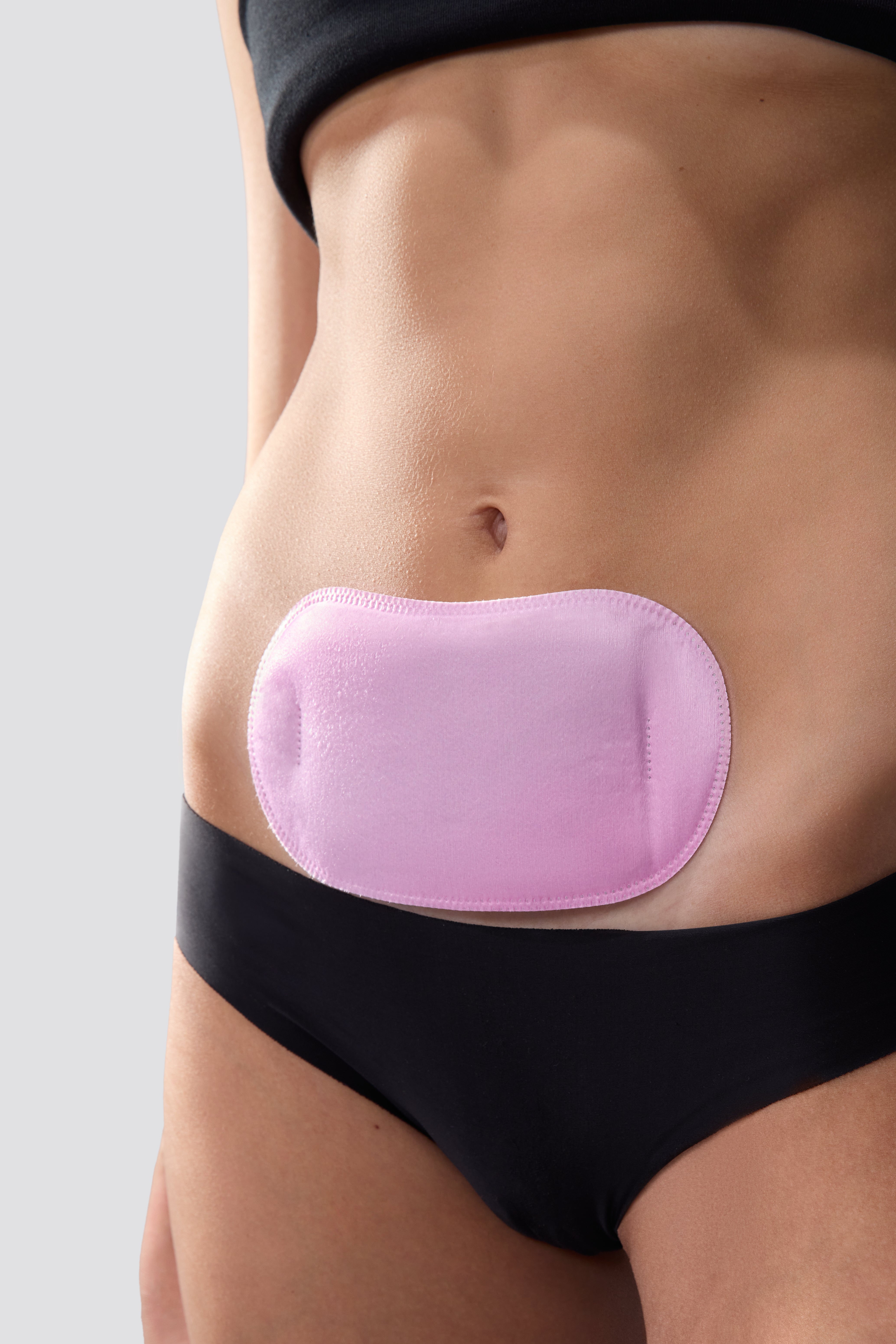 Hotstuff stick on heating pad on woman’s stomach for cramp comfort